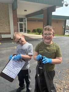 First Graders Clean Up School Grounds for Earth Day