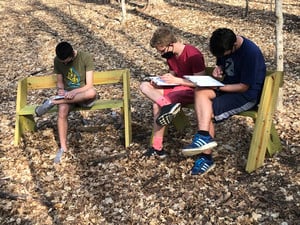 Eighth Grade Studying Genetic Traits in Outdoor Classroom