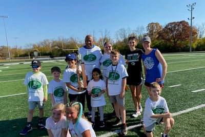 Students and staff pose with participation trophy.