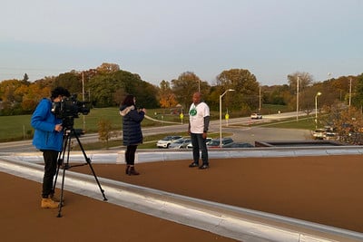 CBS 58 reporter and photojournalist interviewing Mr. Brock.