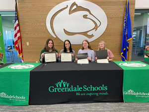 Four students with certificates posing in front of Pantherhead logo.