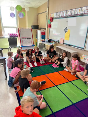 Teacher and students in a morning meeting circle.