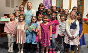 Students and teachers smiling at a special award ceremony.