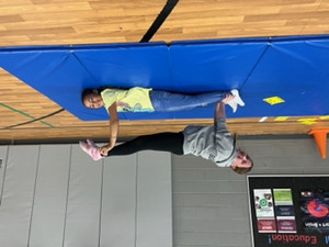 Students Working on Stunts & Tumbling in Physical Education Class