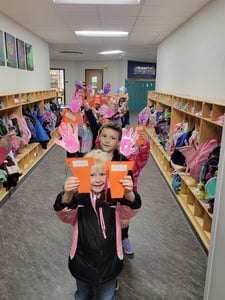 Time 4 Learning students line up to deliver May Day treats to neighbors.